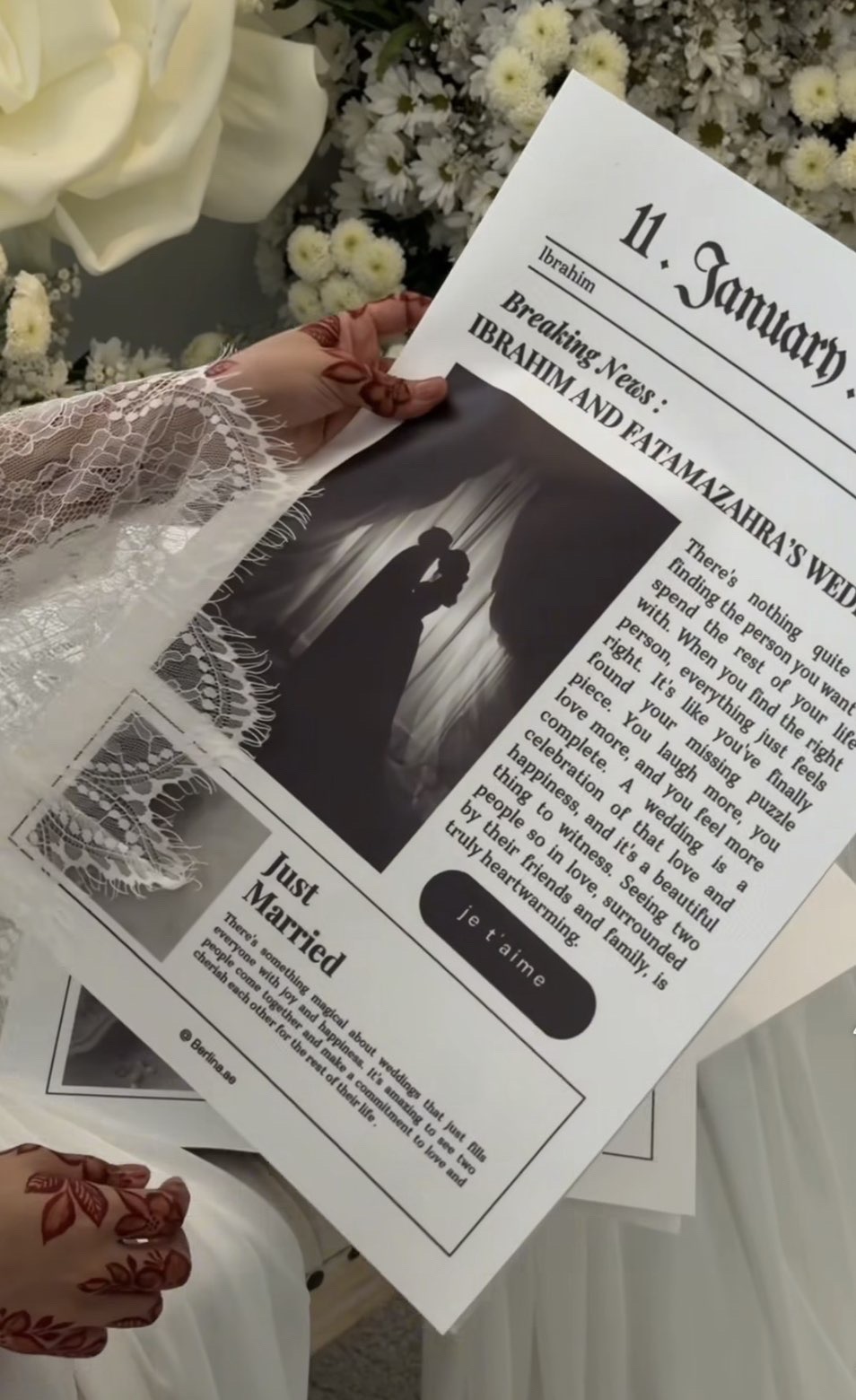 Bride holding a custom wedding newspaper announcing ‘Just Married’